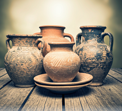 5 pieces of ancient pottery on a wooden deck